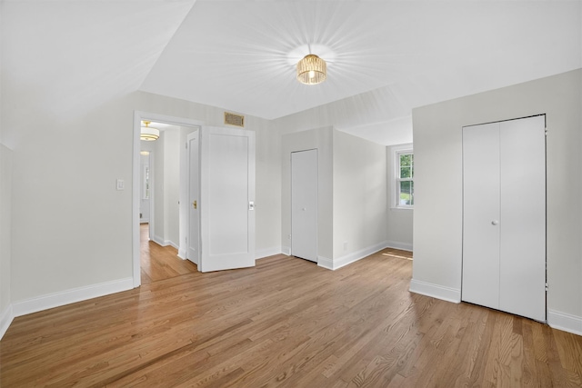 15 Benedict Ave, Eastchester, NY 10709 - unfurnished bedroom with light wood-type flooring and multiple closets