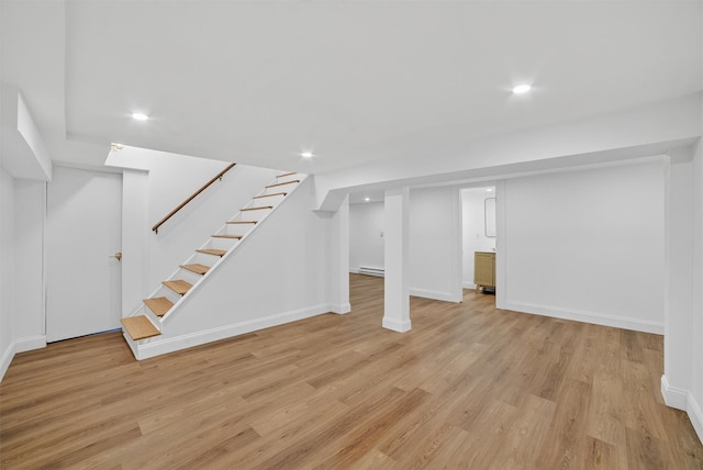 15 Benedict Ave, Eastchester, NY 10709 - finished below grade area with light wood finished floors, recessed lighting, stairs, and a baseboard heating unit