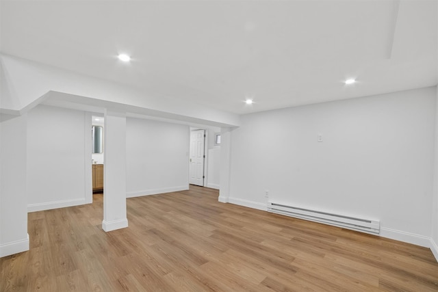 15 Benedict Ave, Eastchester, NY 10709 - finished basement featuring a baseboard heating unit, light wood-style floors, and recessed lighting