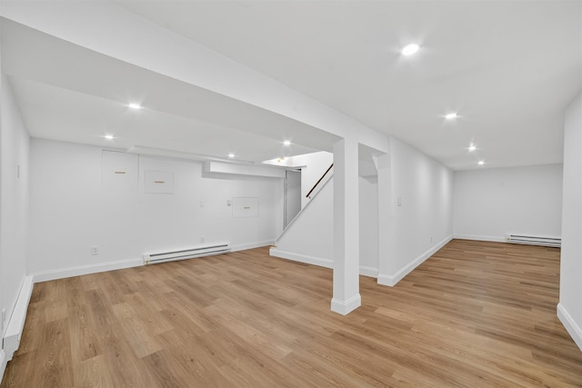 15 Benedict Ave, Eastchester, NY 10709 - finished basement featuring a baseboard radiator, light wood-style flooring, stairs, and recessed lighting