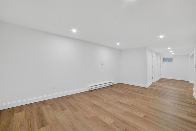15 Benedict Ave, Eastchester, NY 10709 - empty room with a baseboard heating unit, light wood finished floors, and recessed lighting