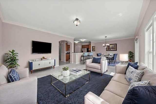 13 Nicole Ct, Copiague, NY 11726 - living room featuring arched walkways, a chandelier, and ornamental molding