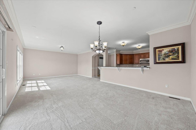 13 Nicole Ct, Copiague, NY 11726 - unfurnished living room featuring a chandelier, crown molding, light colored carpet, and arched walkways