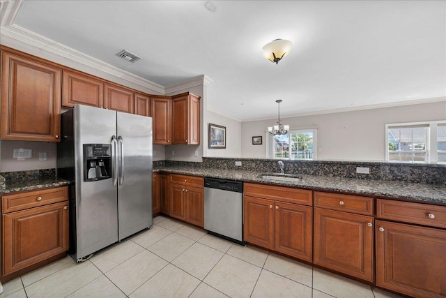 13 Nicole Ct, Copiague, NY 11726 - kitchen featuring stainless steel appliances, a chandelier, ornamental molding, brown cabinets, and light tile patterned flooring