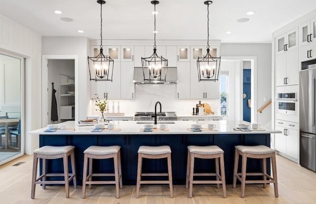 22 Sienna Ct, Dix Hills, NY 11746 - kitchen with a chandelier, oven, freestanding refrigerator, light countertops, and an island with sink
