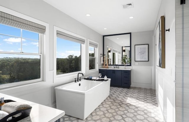 22 Sienna Ct, Dix Hills, NY 11746 - full bath featuring vanity, a freestanding bath, wainscoting, tile patterned floors, and recessed lighting