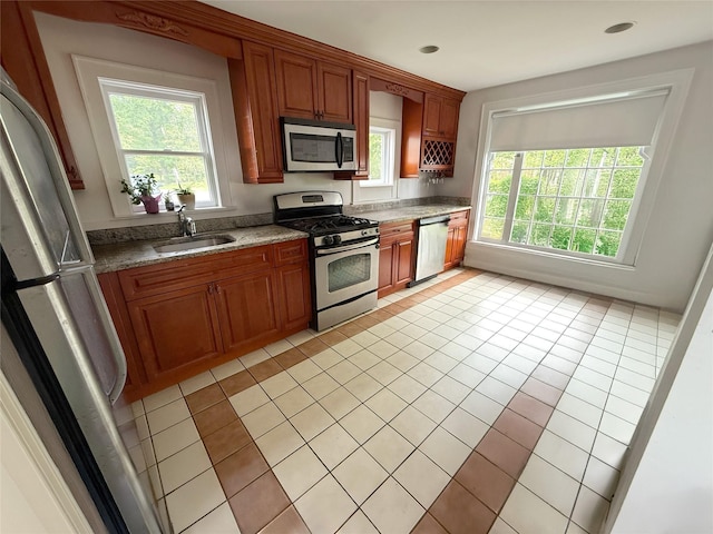 1144 N Ave, New Rochelle, NY 10804 - kitchen with stainless steel appliances, light tile patterned floors, brown cabinets, and light stone countertops