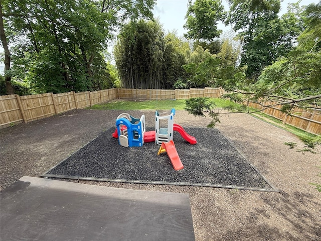 1144 N Ave, New Rochelle, NY 10804 - view of jungle gym with a fenced backyard and view of scattered trees