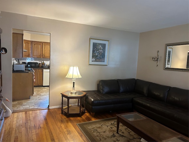 1569 11th St, West Babylon, NY 11704 - living room featuring light wood-style floors and baseboards
