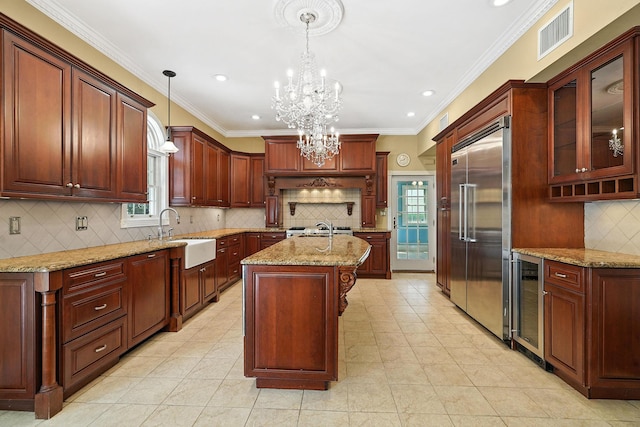 2 Ann Pl, Valhalla, NY 10595 - kitchen with built in fridge, beverage cooler, plenty of natural light, a kitchen island with sink, and ornamental molding