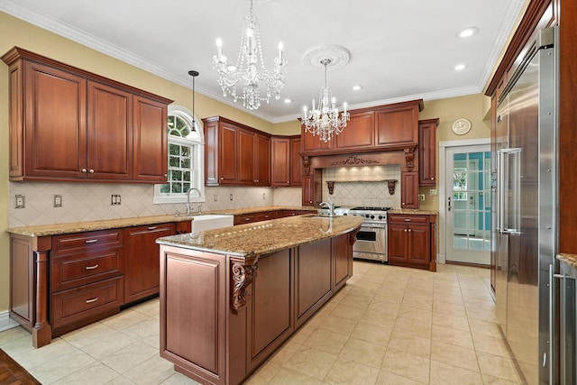 2 Ann Pl, Valhalla, NY 10595 - kitchen with high quality appliances, a chandelier, an island with sink, decorative light fixtures, and crown molding