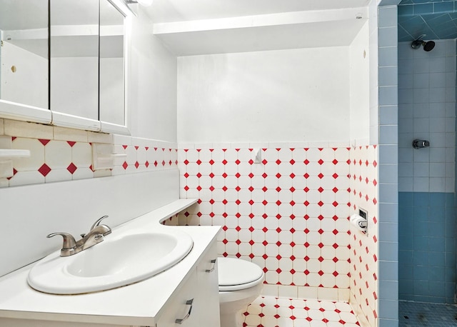 2 Ann Pl, Valhalla, NY 10595 - full bathroom with tiled shower, vanity, tile walls, wainscoting, and tile patterned floors