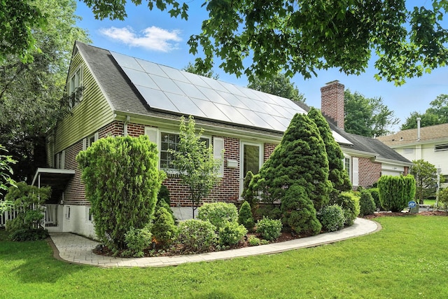 2 Ann Pl, Valhalla, NY 10595 - view of property exterior featuring roof mounted solar panels, brick siding, a yard, and a chimney
