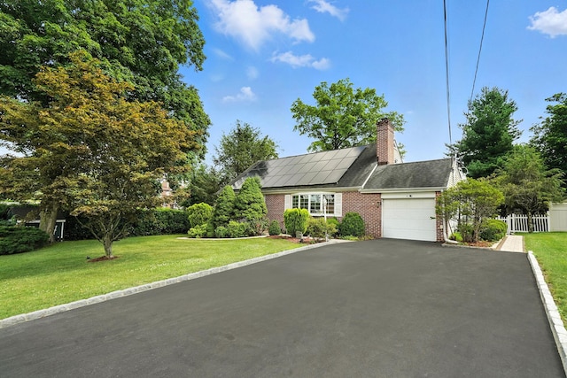 2 Ann Pl, Valhalla, NY 10595 - view of front of house with an attached garage, brick siding, asphalt driveway, solar panels, and a chimney