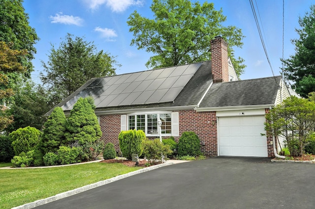 2 Ann Pl, Valhalla, NY 10595 - cape cod home with a garage, brick siding, asphalt driveway, solar panels, and a chimney