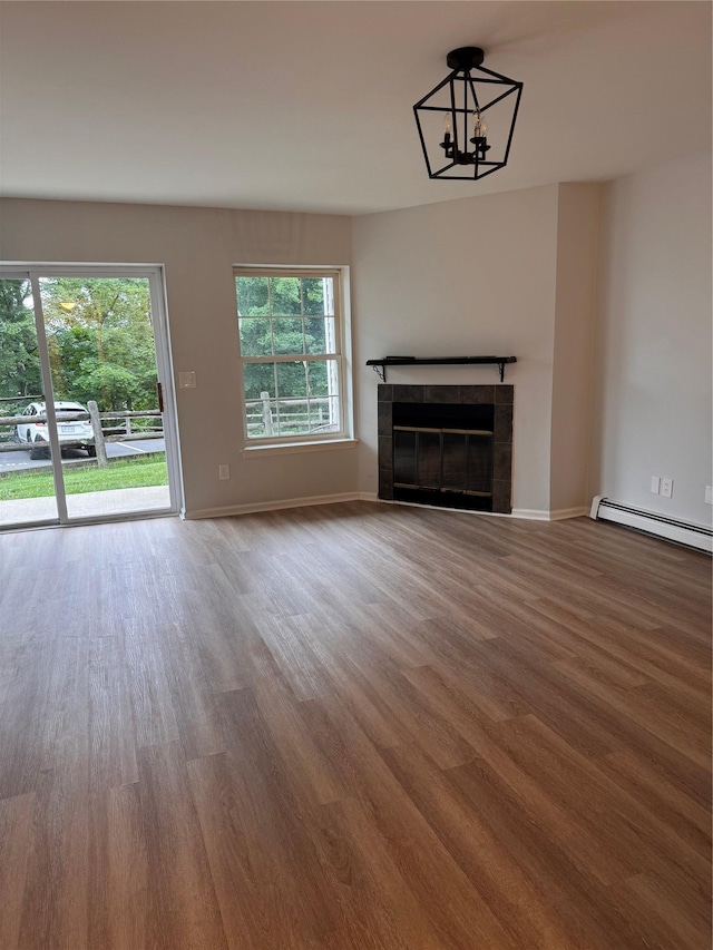 21 Lexington Hl Unit 8, Harriman, NY 10926 - unfurnished living room with wood finished floors, baseboard heating, healthy amount of natural light, and a fireplace