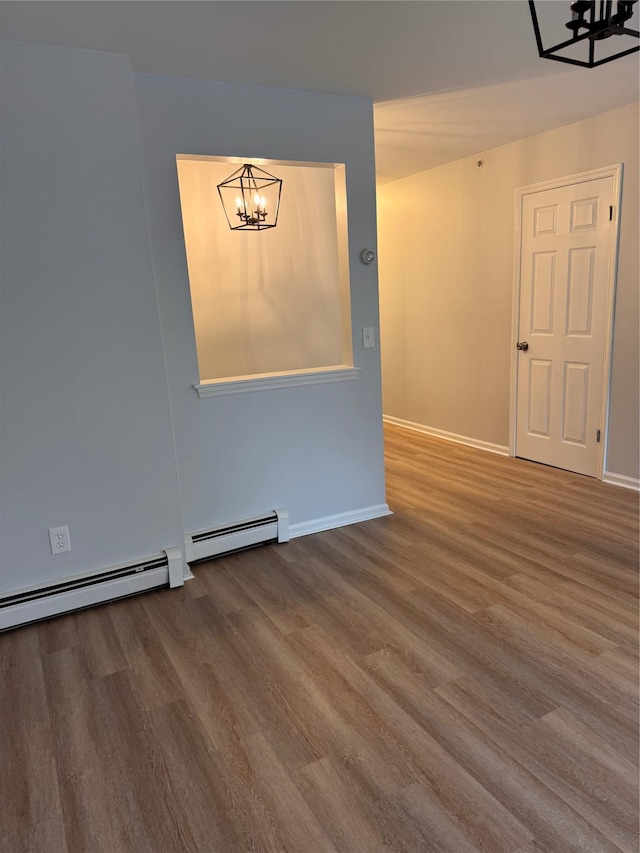 21 Lexington Hl Unit 8, Harriman, NY 10926 - empty room featuring a chandelier, wood finished floors, and baseboard heating