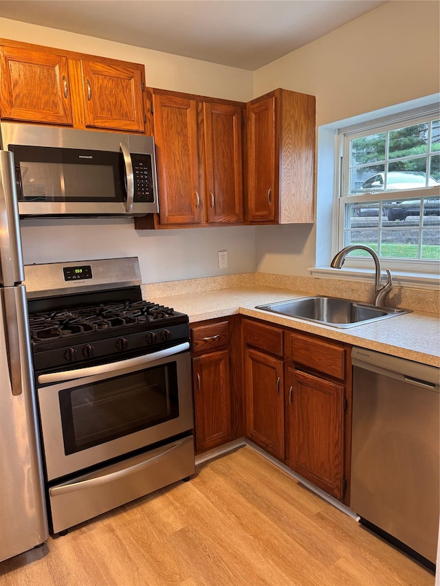 21 Lexington Hl Unit 8, Harriman, NY 10926 - kitchen with appliances with stainless steel finishes, light wood-style floors, light countertops, and brown cabinets