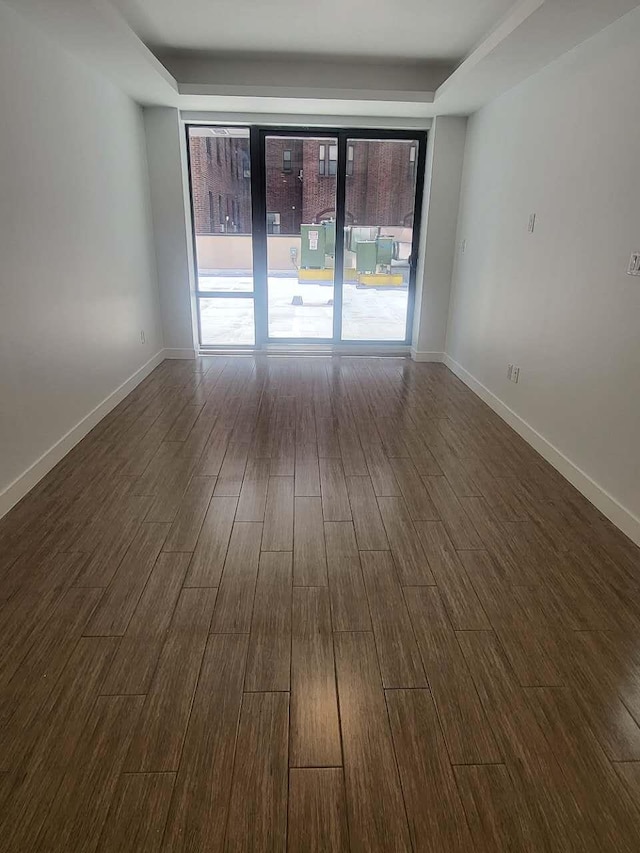 4218 147th St Unit 2E, Flushing, NY 11355 - empty room with dark wood-style flooring and a raised ceiling