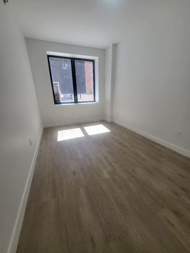 4218 147th St Unit 2E, Flushing, NY 11355 - spare room with wood finished floors and baseboards