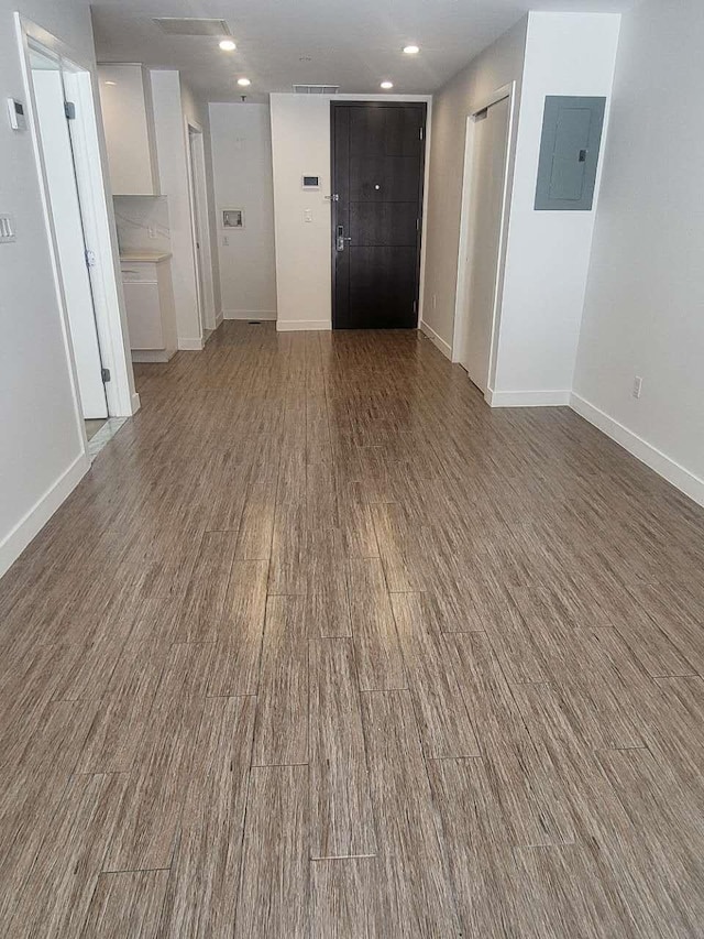 4218 147th St Unit 2E, Flushing, NY 11355 - empty room featuring electric panel, wood finished floors, and recessed lighting
