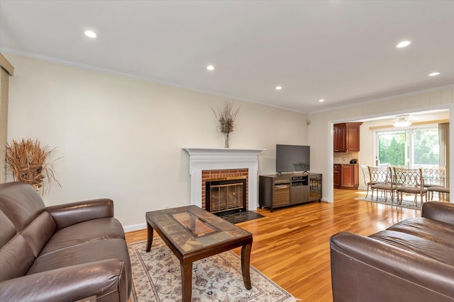 18 Gainsboro Ln, Syosset, NY 11791 - living room with ornamental molding, light wood-style flooring, a brick fireplace, and recessed lighting