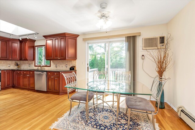 18 Gainsboro Ln, Syosset, NY 11791 - dining space featuring a baseboard radiator, light wood-style flooring, a ceiling fan, rail lighting, and a wall unit AC