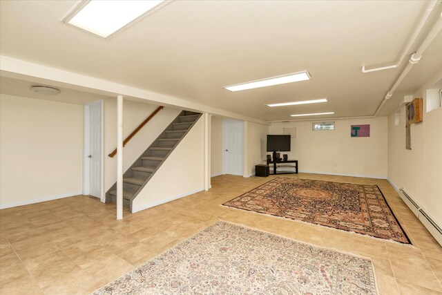 18 Gainsboro Ln, Syosset, NY 11791 - below grade area with stairway, light tile patterned floors, and a baseboard radiator