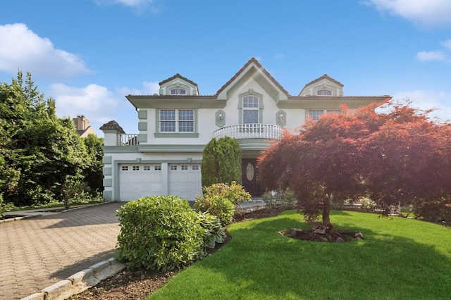 24-56 Little Neck Blvd, Bayside, NY 11360 - view of front of house featuring stucco siding, a balcony, an attached garage, a front lawn, and decorative driveway