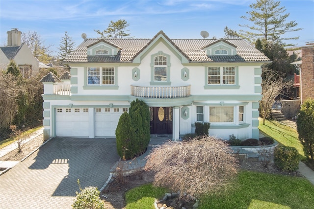 24-56 Little Neck Blvd, Bayside, NY 11360 - view of front facade with stucco siding, decorative driveway, and a garage