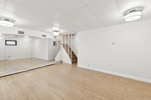 24-56 Little Neck Blvd, Bayside, NY 11360 - finished below grade area with wood finished floors, stairway, a drop ceiling, and baseboard heating