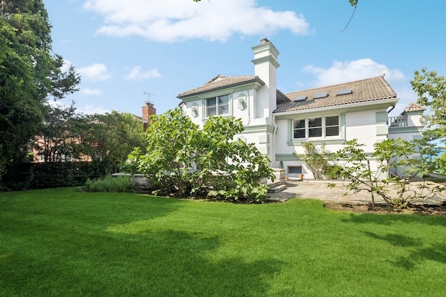 24-56 Little Neck Blvd, Bayside, NY 11360 - rear view of house with stucco siding, a yard, a tile roof, and a chimney