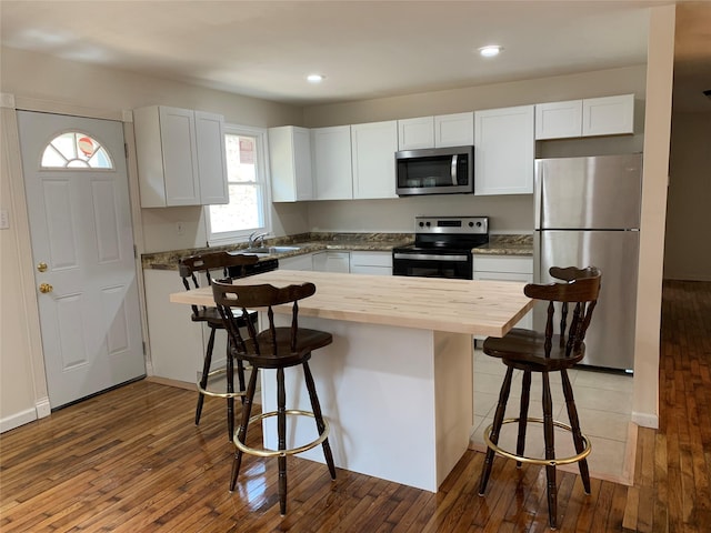 604 Basket Rd, Long Eddy, NY 12760 - kitchen with stainless steel appliances, butcher block counters, a kitchen breakfast bar, hardwood / wood-style flooring, and recessed lighting