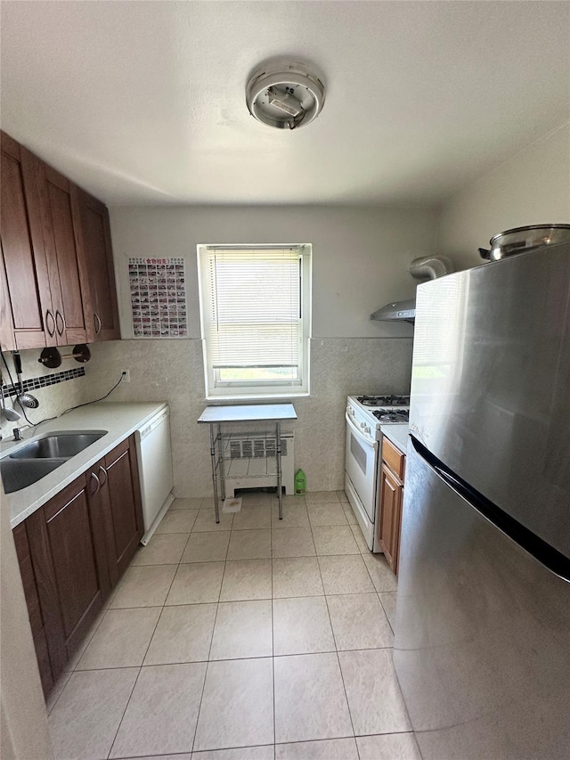 150-85 70th Rd Unit 2B, Flushing, NY 11367 - kitchen featuring white appliances, radiator, light countertops, tile walls, and wall chimney exhaust hood