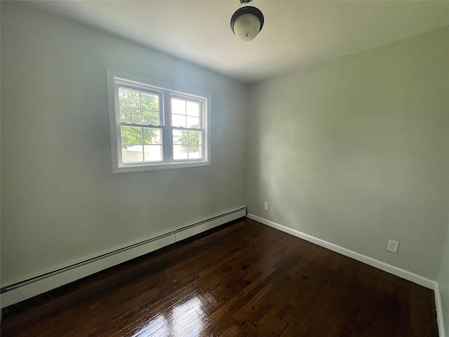 10 Kirby Ln, Central Islip, NY 11722 - spare room featuring a baseboard heating unit and dark wood-style floors