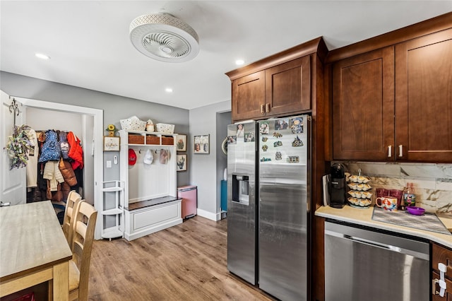 89 3rd Ave, Massapequa Park, NY 11762 - kitchen with stainless steel appliances, light countertops, light wood finished floors, and recessed lighting