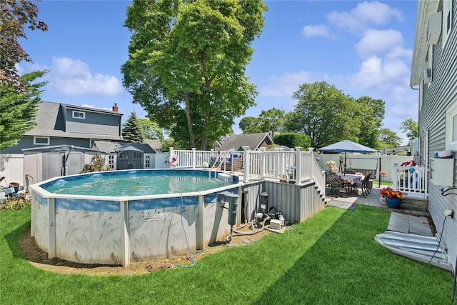 89 3rd Ave, Massapequa Park, NY 11762 - view of pool featuring a storage unit, a fenced backyard, and outdoor dining area