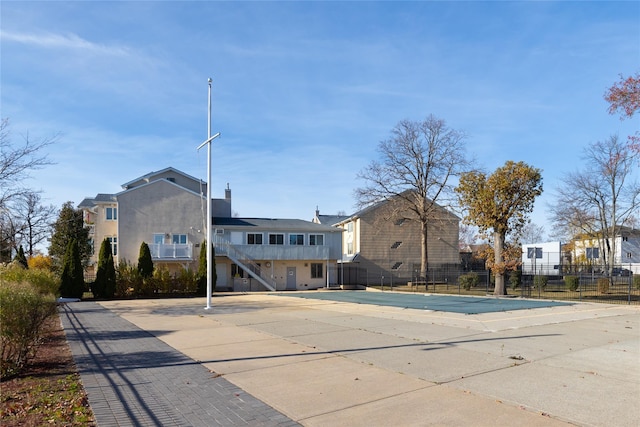 221 Winding Woods Loop Unit 55, Staten Island, NY 10307 - rear view of house with stairway and stucco siding