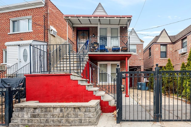 989 Sacket Ave, Bronx, NY 10462 - view of property featuring brick siding, a fenced front yard, a gate, and a wall mounted air conditioner
