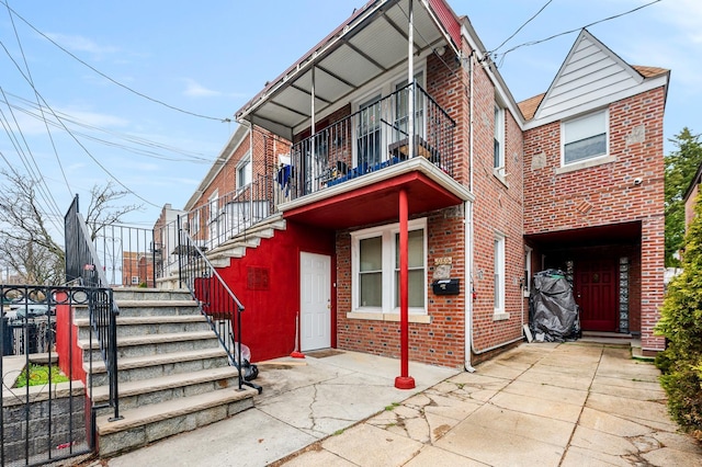 989 Sacket Ave, Bronx, NY 10462 - view of property with stairway, brick siding, and a balcony
