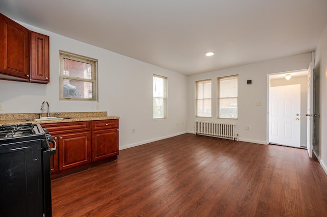 989 Sacket Ave, Bronx, NY 10462 - kitchen featuring radiator, range with gas cooktop, healthy amount of natural light, dark wood finished floors, and recessed lighting