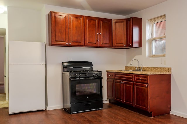 989 Sacket Ave, Bronx, NY 10462 - kitchen with freestanding refrigerator, black range with gas stovetop, dark wood-style floors, and dark brown cabinets