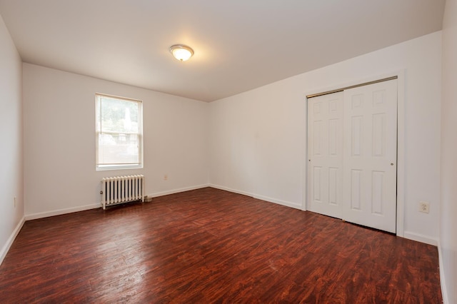 989 Sacket Ave, Bronx, NY 10462 - unfurnished bedroom with radiator heating unit, dark wood-style floors, and a closet