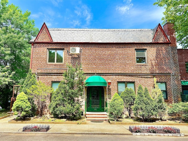7267 Yellowstone Blvd, Forest Hills, NY 11375 - view of front facade featuring brick siding, a high end roof, and entry steps