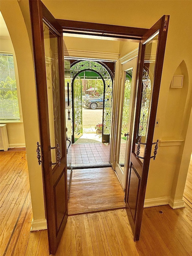 7267 Yellowstone Blvd, Forest Hills, NY 11375 - entryway with light wood-style floors, arched walkways, and radiator