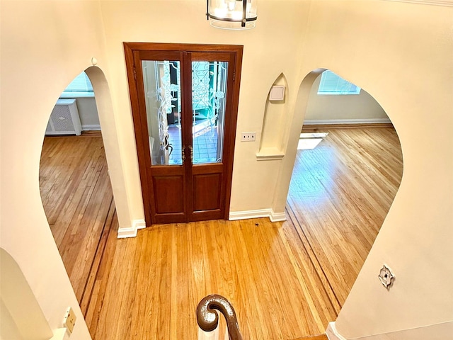 7267 Yellowstone Blvd, Forest Hills, NY 11375 - foyer entrance featuring arched walkways, light wood-style flooring, and healthy amount of natural light