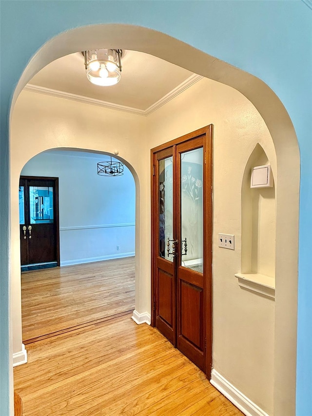7267 Yellowstone Blvd, Forest Hills, NY 11375 - foyer featuring arched walkways, ornamental molding, and light wood-style floors