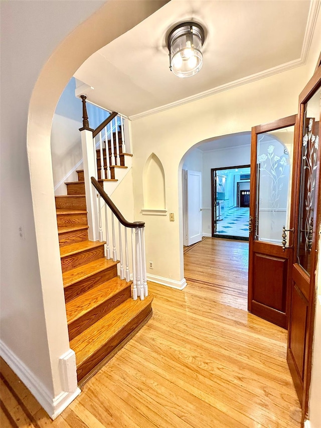 7267 Yellowstone Blvd, Forest Hills, NY 11375 - entryway with arched walkways, light wood finished floors, stairs, and crown molding
