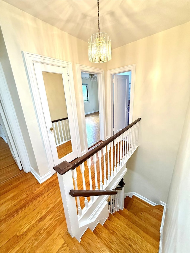 7267 Yellowstone Blvd, Forest Hills, NY 11375 - staircase with a chandelier and wood finished floors