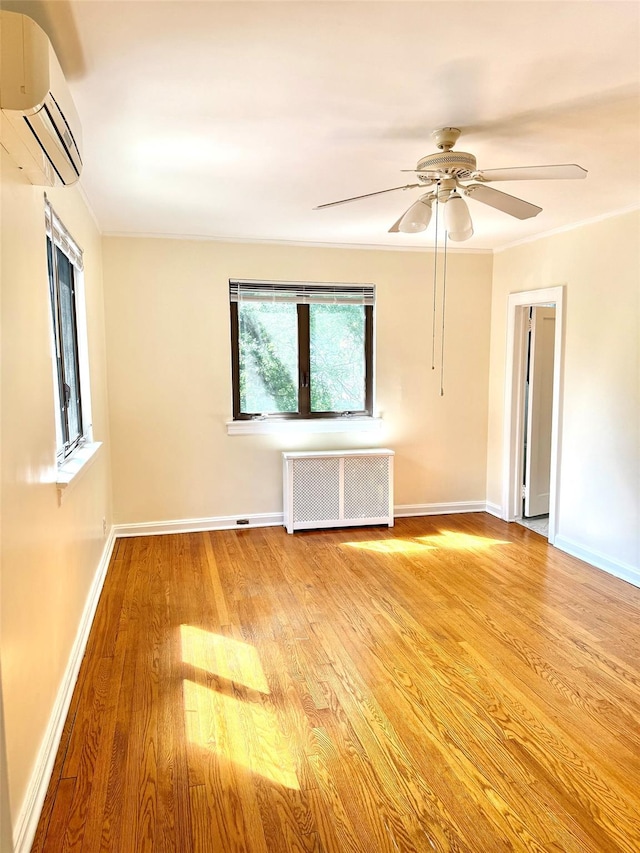 7267 Yellowstone Blvd, Forest Hills, NY 11375 - unfurnished room with radiator heating unit, a wall mounted AC, wood finished floors, ceiling fan, and crown molding